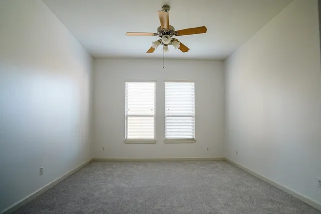a bathroom with a tub a double vanity sink and mirror