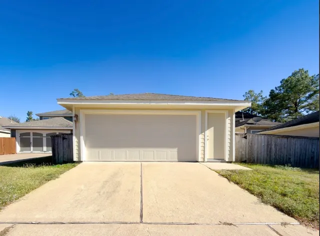 a view of backyard with potted plants and wooden fence