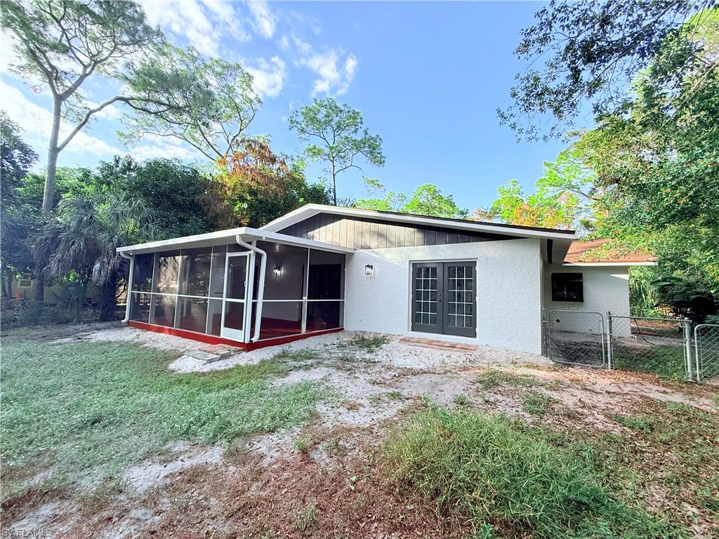 3330 13th Avenue Southwest Naples, FL 34117 - Photo 12 of 50 a view of a house with a yard and large tree