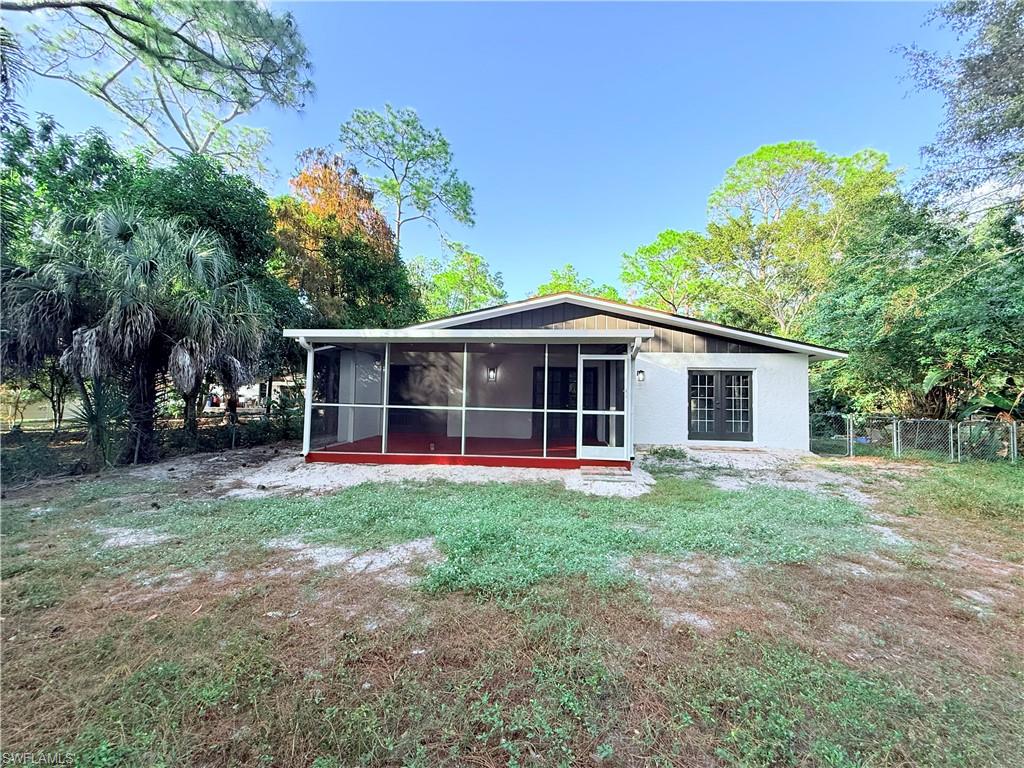 3330 13th Avenue Southwest Naples, FL 34117 - Photo 13 of 50 a front view of a house with a yard and trees
