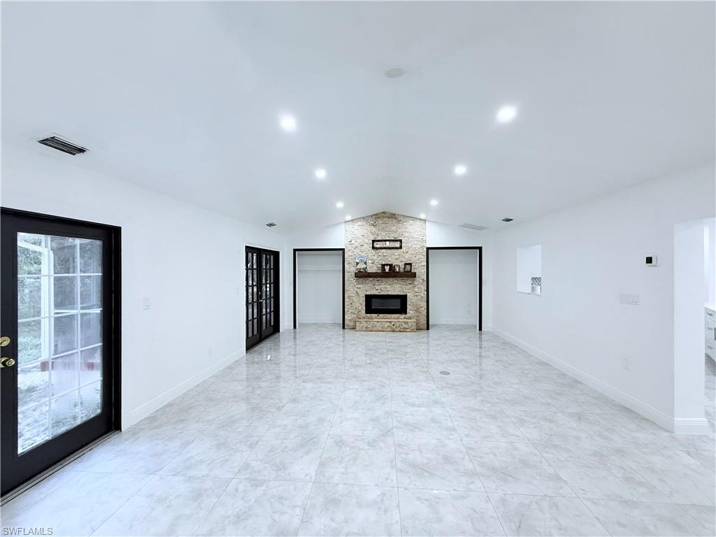 3330 13th Avenue Southwest Naples, FL 34117 - Photo 25 of 50 an empty room with a cabinet and mirrors