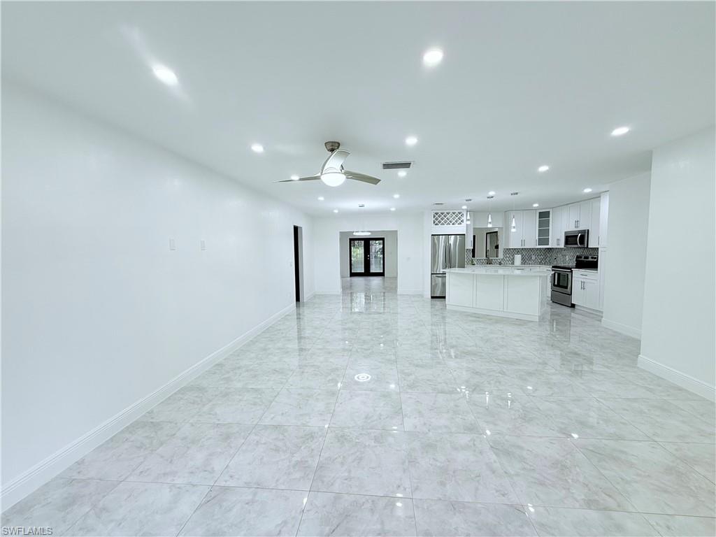 3330 13th Avenue Southwest Naples, FL 34117 - Photo 29 of 50 a view of a kitchen with kitchen island granite countertop living room