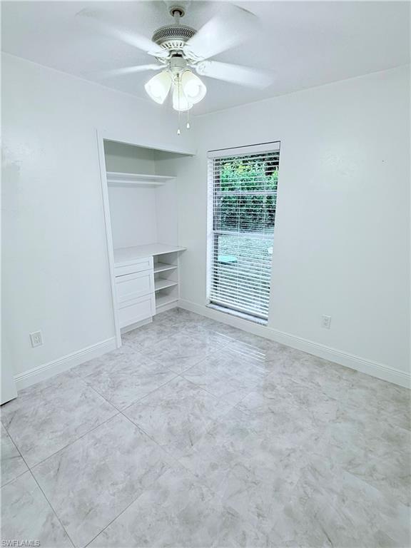 3330 13th Avenue Southwest Naples, FL 34117 - Photo 35 of 50 an empty room with a empty space and a ceiling fan