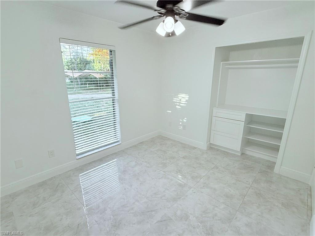 3330 13th Avenue Southwest Naples, FL 34117 - Photo 36 of 50 an empty room with windows and fan