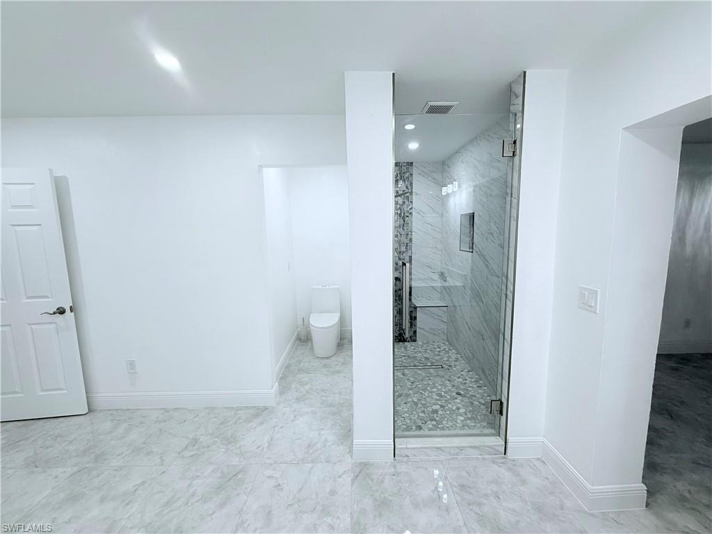 3330 13th Avenue Southwest Naples, FL 34117 - Photo 44 of 50 a bathroom with a granite countertop shower and a sink