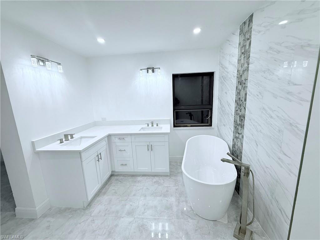 3330 13th Avenue Southwest Naples, FL 34117 - Photo 46 of 50 a bathroom with a sink a toilet and shower