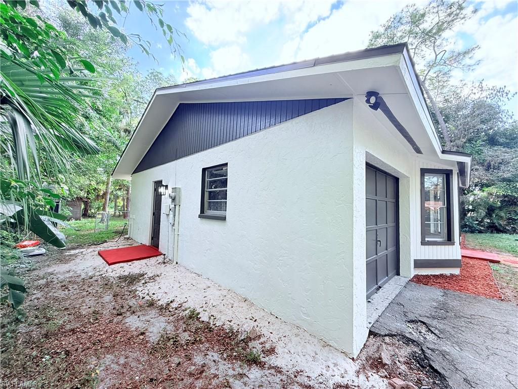 3330 13th Avenue Southwest Naples, FL 34117 - Photo 7 of 50 a backyard of a house with wooden floor