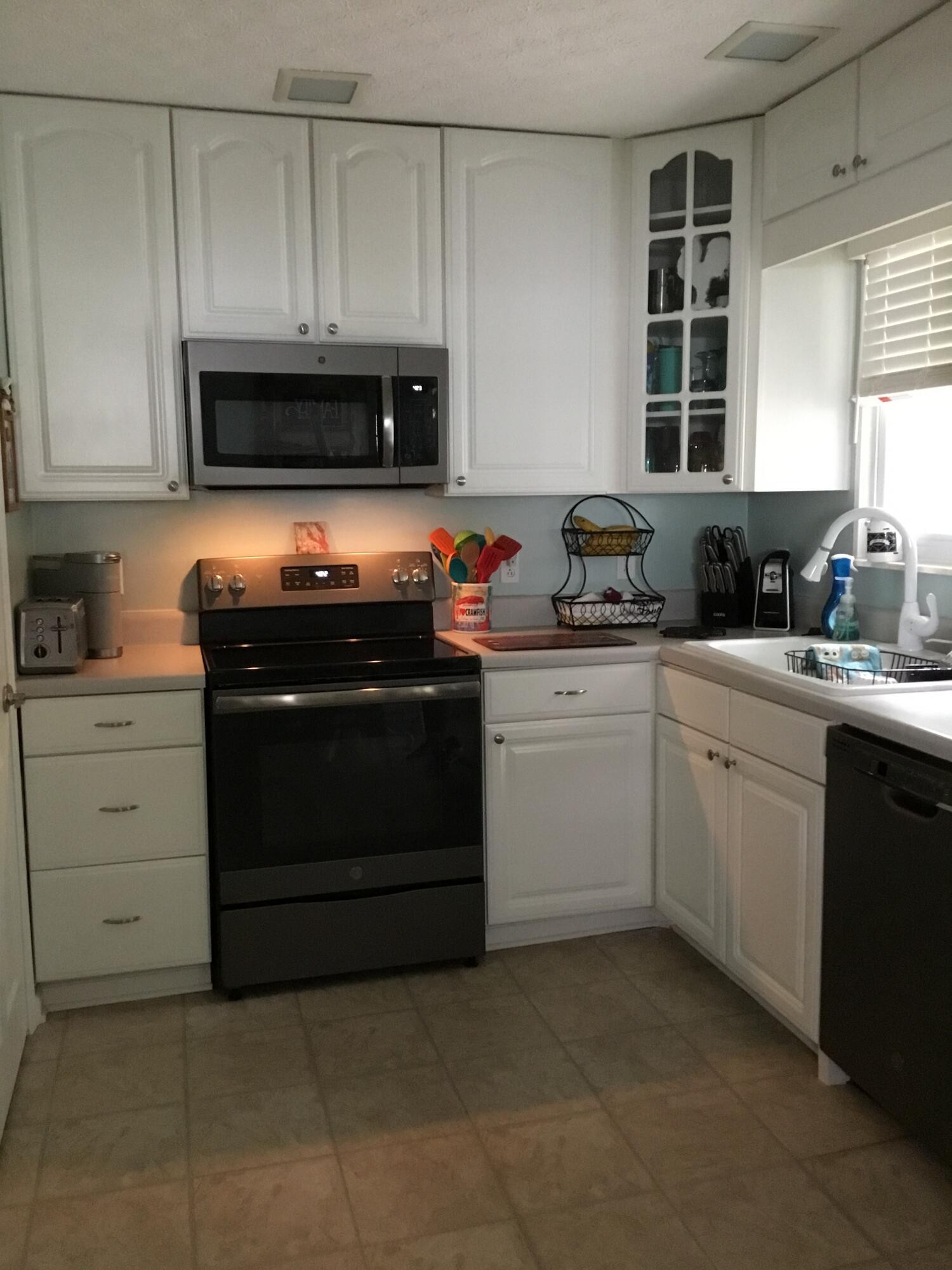 121 East Arrowwood Road Oak Ridge, TN 37830 - Photo 3 of 26 a kitchen with white cabinets and appliances