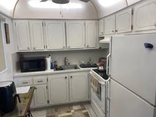 a kitchen with stainless steel appliances granite countertop a sink a stove a microwave and cabinets