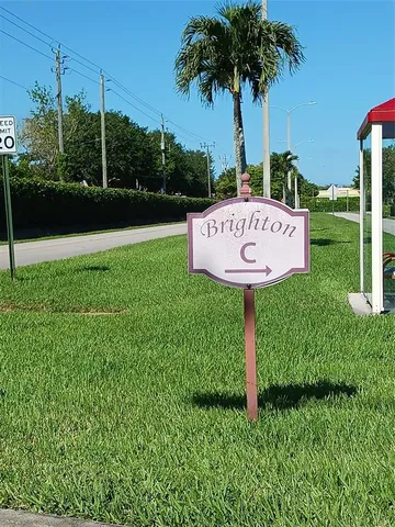 a sign board with a park bench