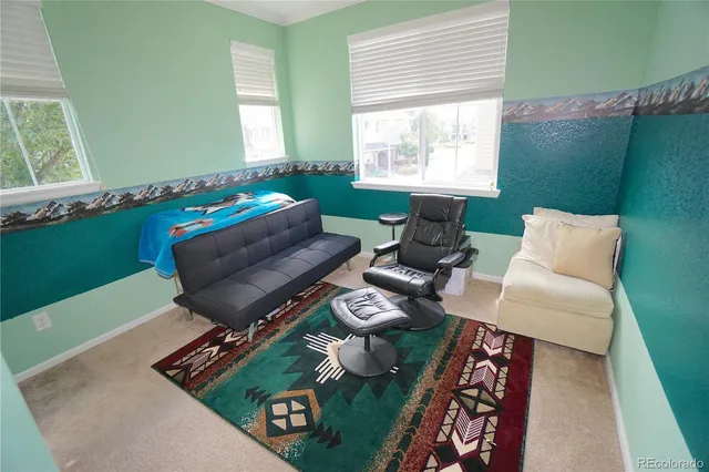 a bathroom with a granite countertop toilet a sink a mirror and shower