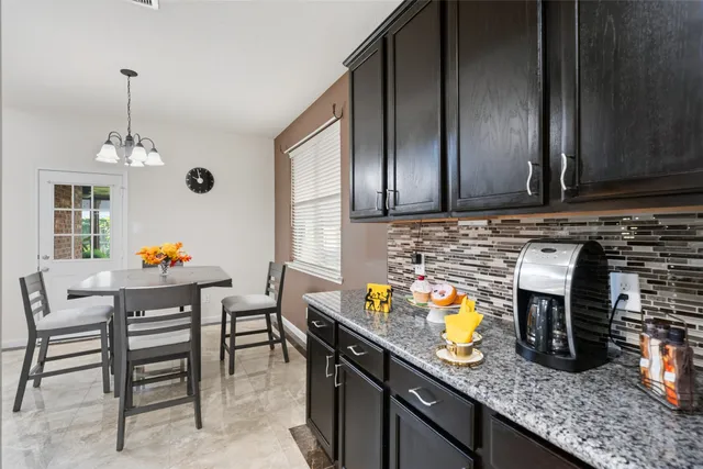 a kitchen with stainless steel appliances granite countertop a sink and a stove