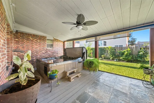a kitchen with a sink a counter top space and living room view