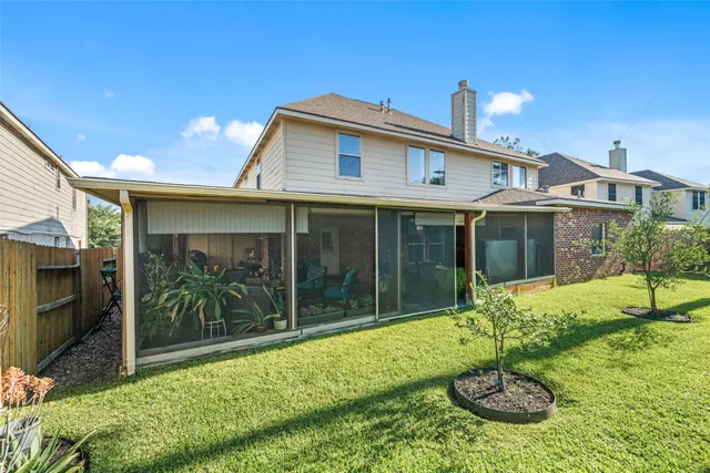 a view of a house with backyard and porch