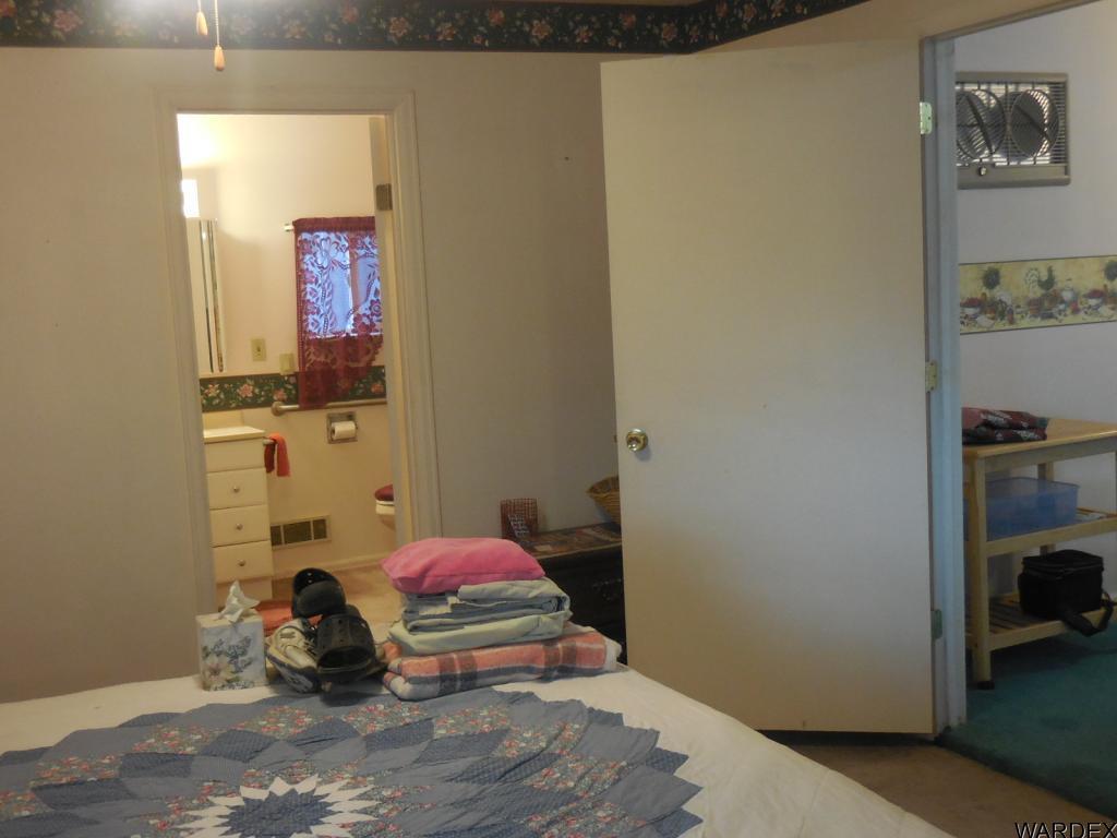 708 Ocotillo Lane Quartzsite, AZ 85346 - Photo 14 of 17 a bedroom with a bed and a view of bathroom