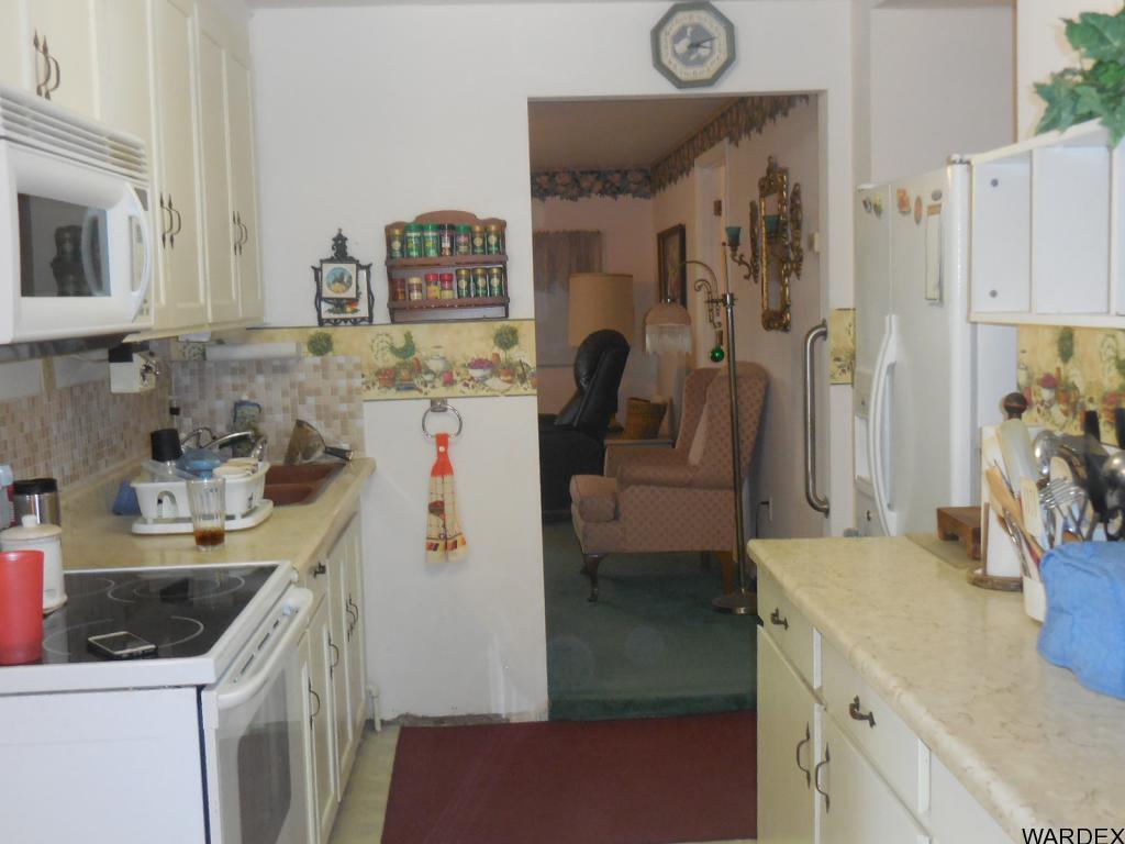 708 Ocotillo Lane Quartzsite, AZ 85346 - Photo 8 of 17 a kitchen with a sink and a refrigerator