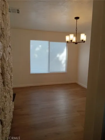 a view of a room with wooden floor and windows