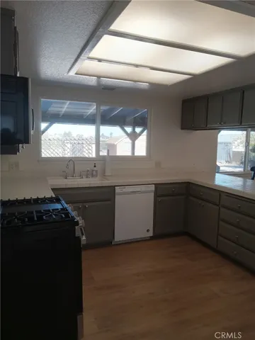 a kitchen with a sink stove and microwave