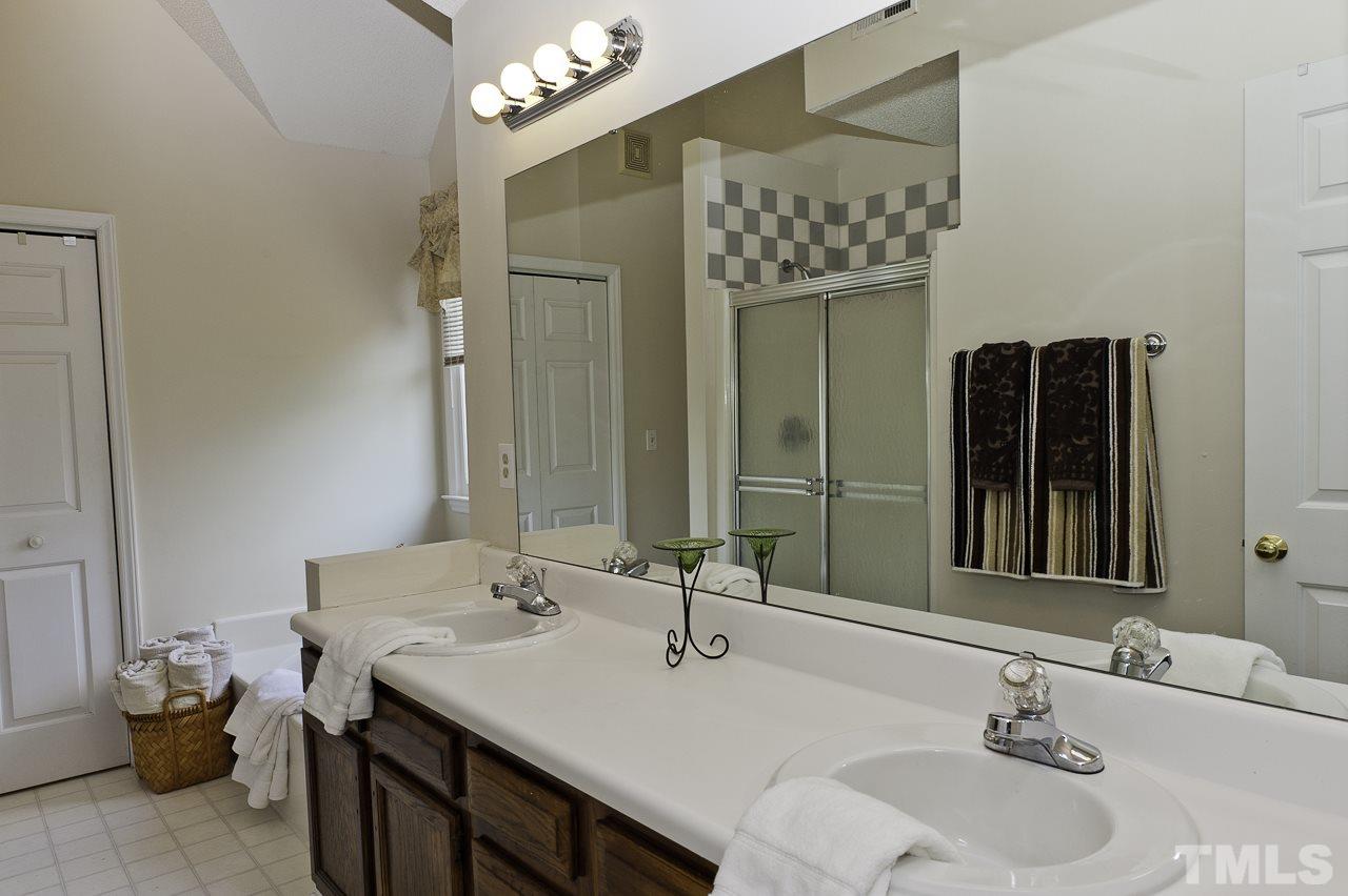 4517 Birmingham Way Raleigh, NC 27604 - Photo 16 of 25 a bathroom with a sink and a mirror