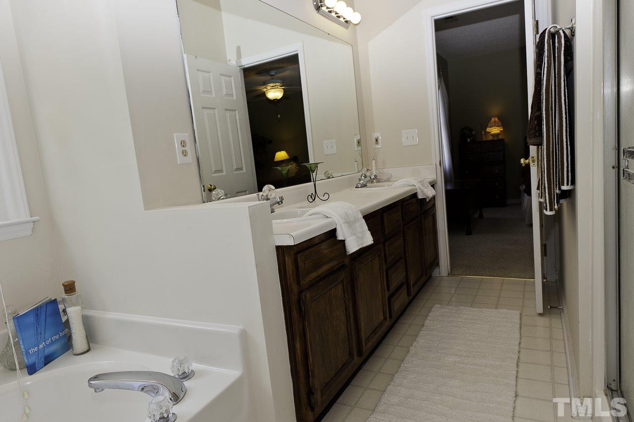 4517 Birmingham Way Raleigh, NC 27604 - Photo 18 of 25 a bathroom with a double vanity sink toilet and tub