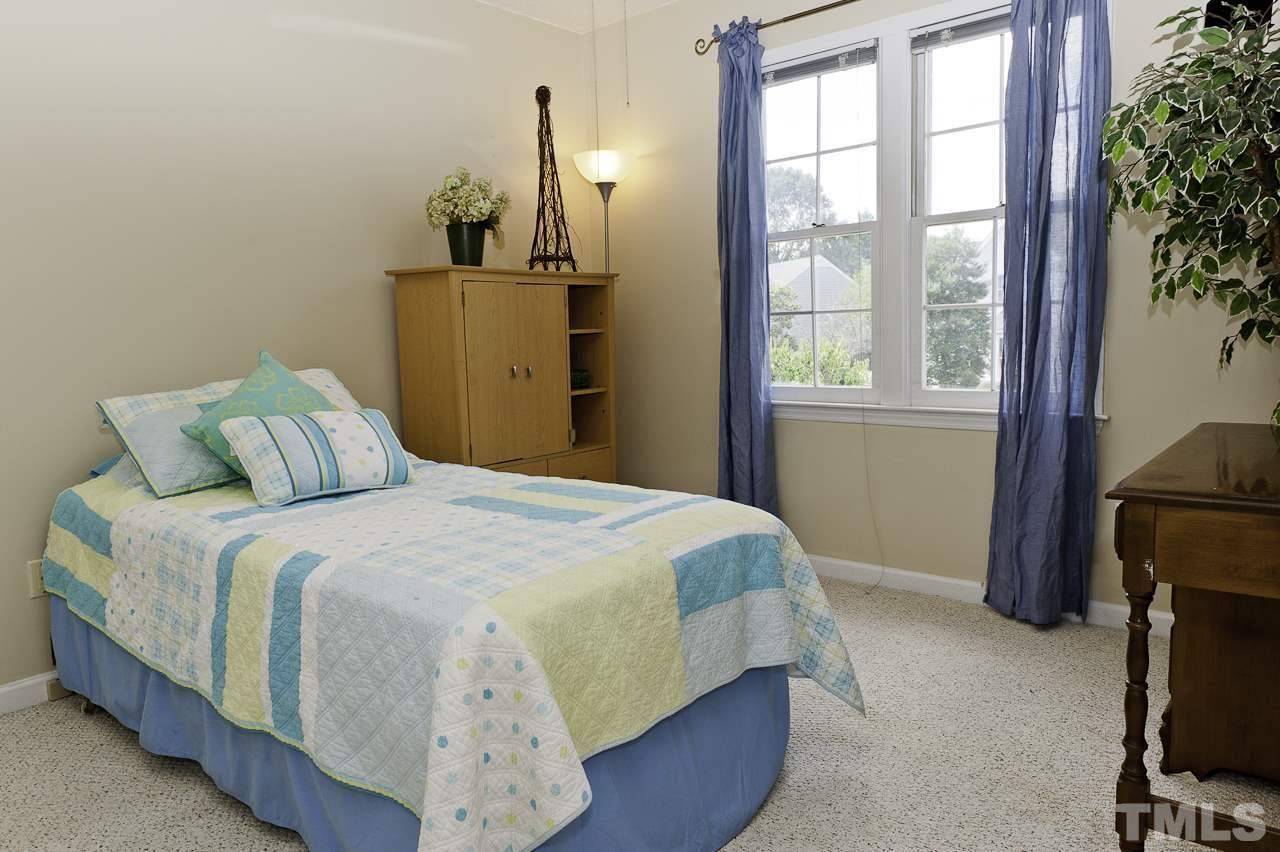 4517 Birmingham Way Raleigh, NC 27604 - Photo 19 of 25 a bedroom with a bed and a window