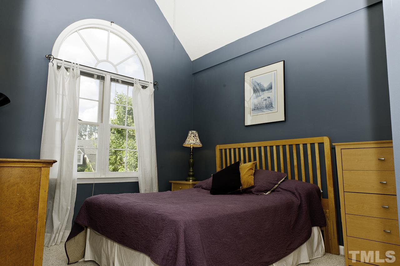 4517 Birmingham Way Raleigh, NC 27604 - Photo 21 of 25 a bedroom with a bed and a window