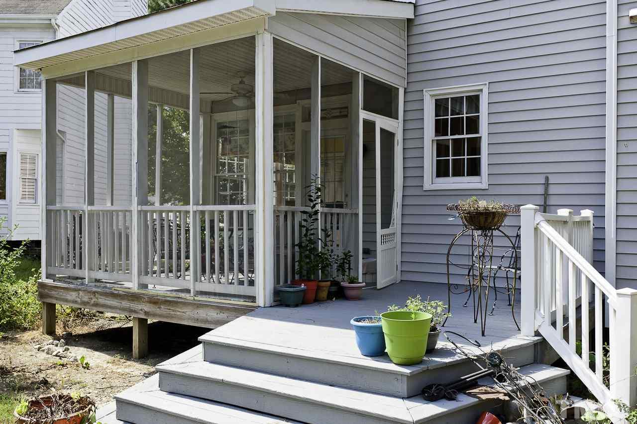 4517 Birmingham Way Raleigh, NC 27604 - Photo 24 of 25 a view of brick house with two chairs and a potted plant