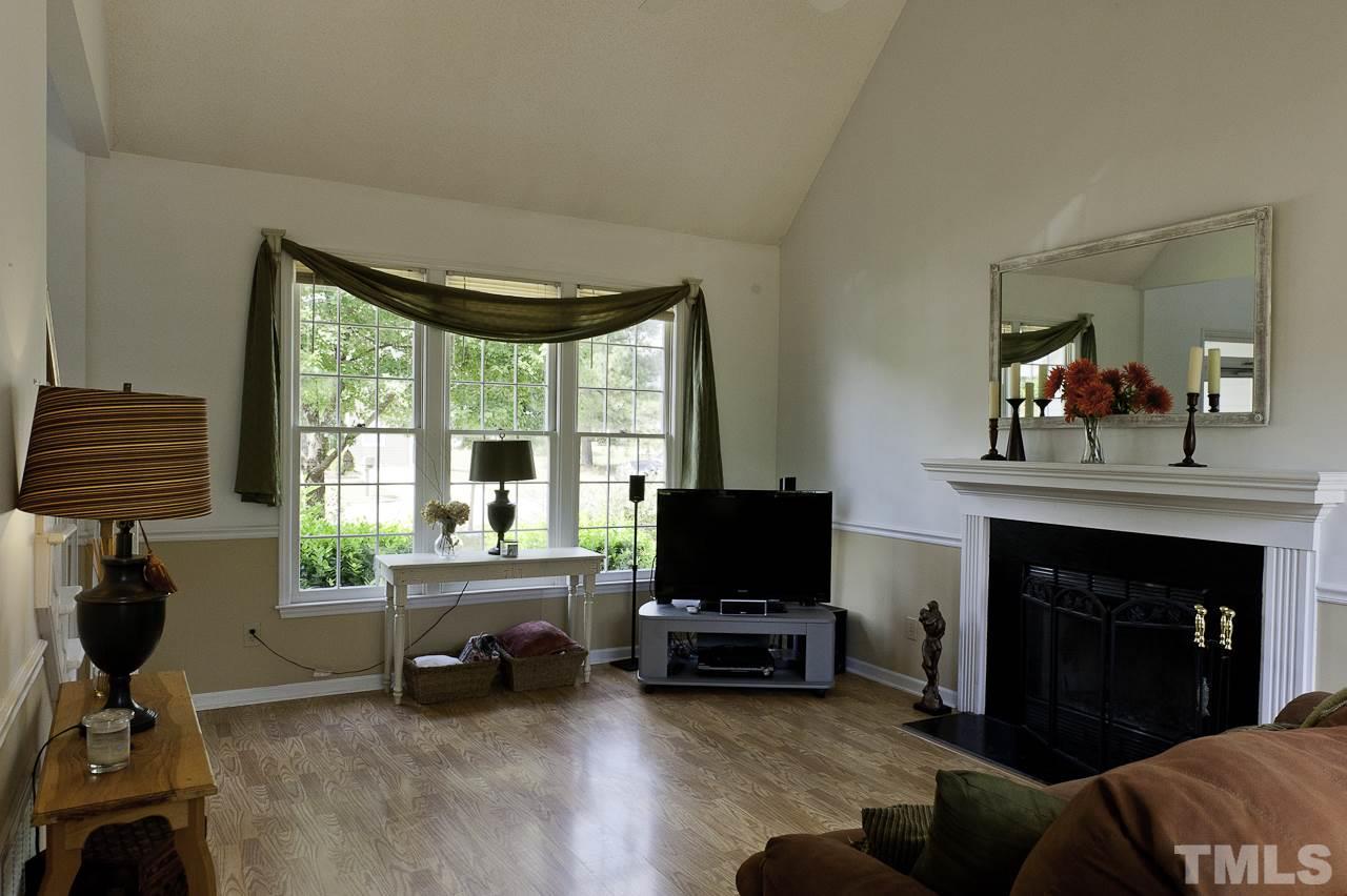 4517 Birmingham Way Raleigh, NC 27604 - Photo 5 of 25 a living room with furniture a fireplace and a flat screen tv