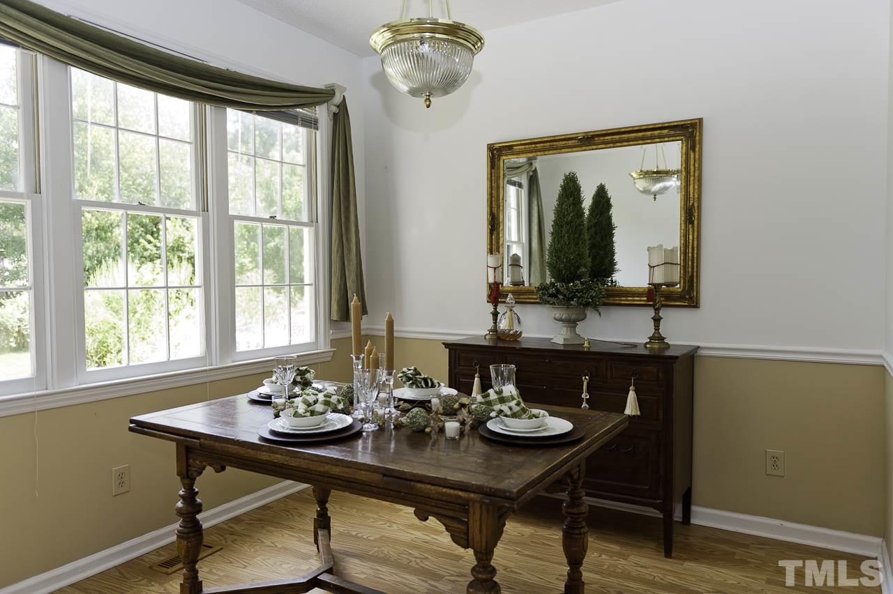 4517 Birmingham Way Raleigh, NC 27604 - Photo 8 of 25 a view of a dining room with furniture window and wooden floor