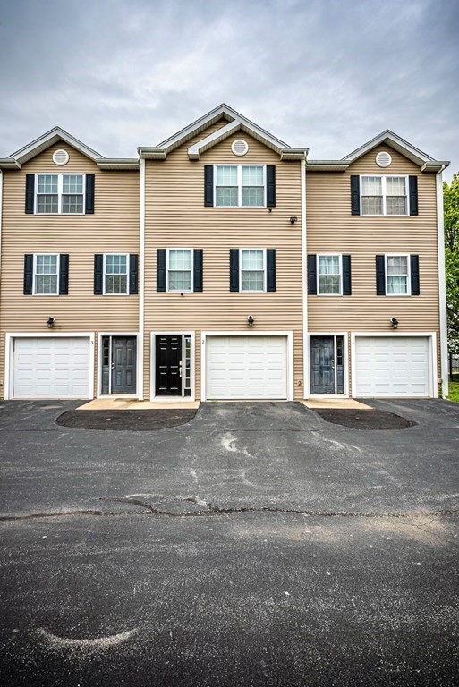1084 Pine Street, Unit 2 Fall River, MA 02723 - Photo 3 of 22 a front view of a house with a yard