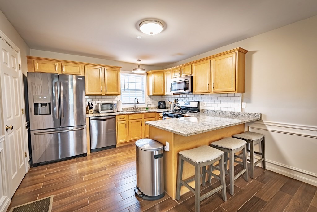 1084 Pine Street, Unit 2 Fall River, MA 02723 - Photo 4 of 22 a kitchen with granite countertop a sink appliances a window and dining table