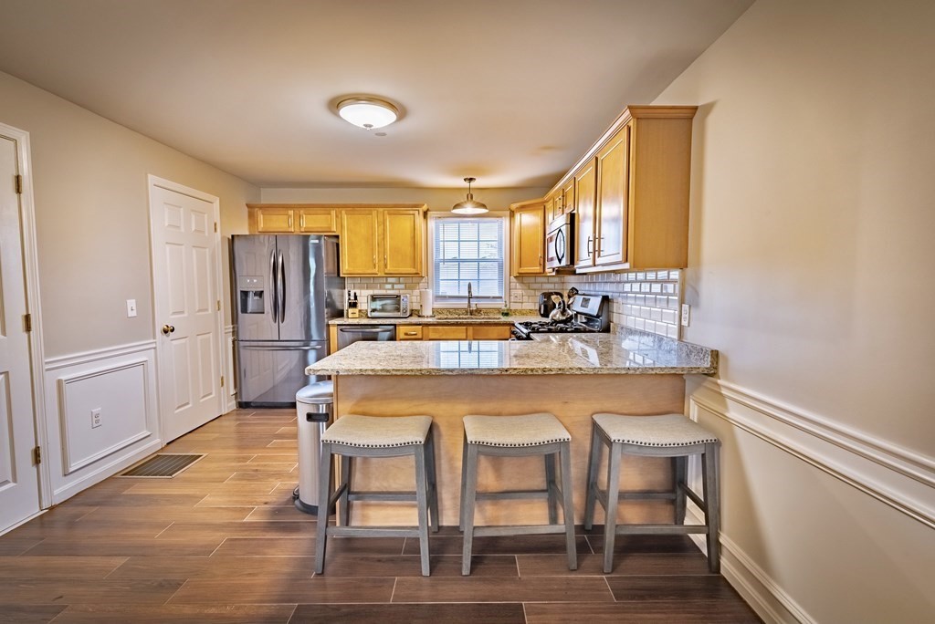 1084 Pine Street, Unit 2 Fall River, MA 02723 - Photo 5 of 22 a large kitchen with a table and chairs
