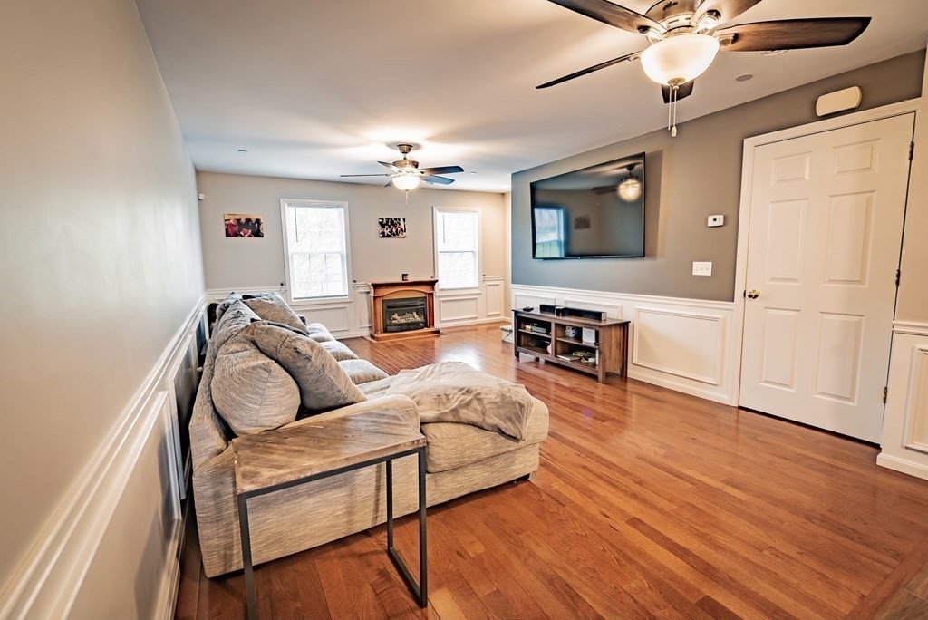 1084 Pine Street, Unit 2 Fall River, MA 02723 - Photo 8 of 22 a living room with furniture and a wooden floor