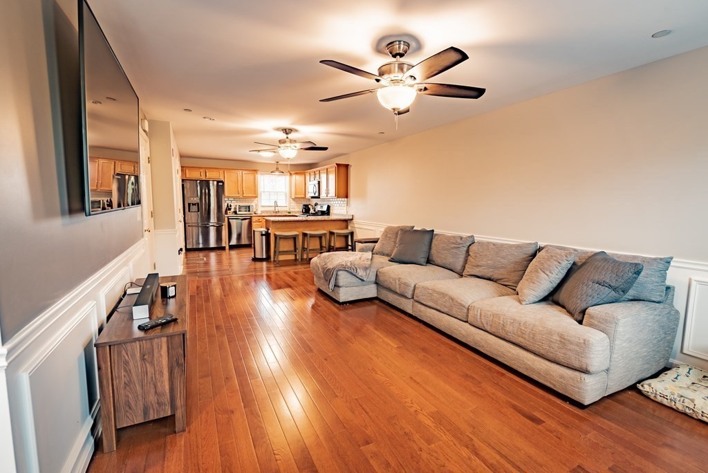 1084 Pine Street, Unit 2 Fall River, MA 02723 - Photo 9 of 22 a living room with furniture and a chandelier
