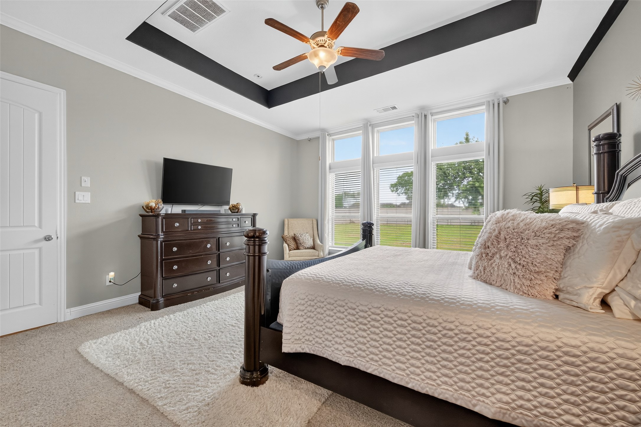 4719 Prairie Springs Lane Rosharon, TX 77583 - Photo 14 of 33 a bedroom with a bed flat screen tv and a large window