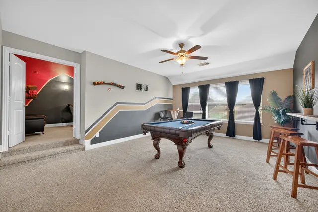 a living room with furniture a rug and a large window