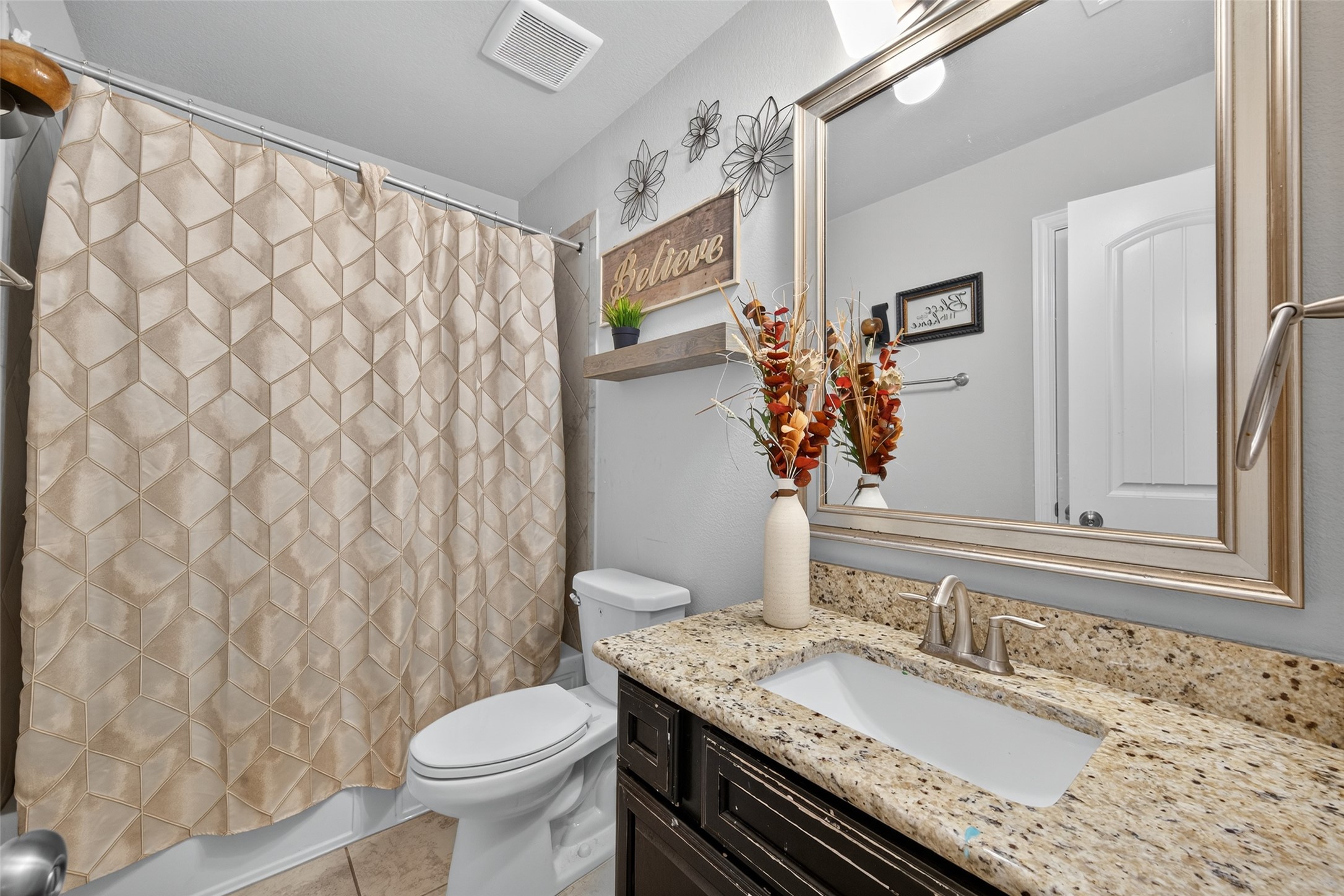 4719 Prairie Springs Lane Rosharon, TX 77583 - Photo 28 of 33 a bathroom with a granite countertop sink toilet and a mirror