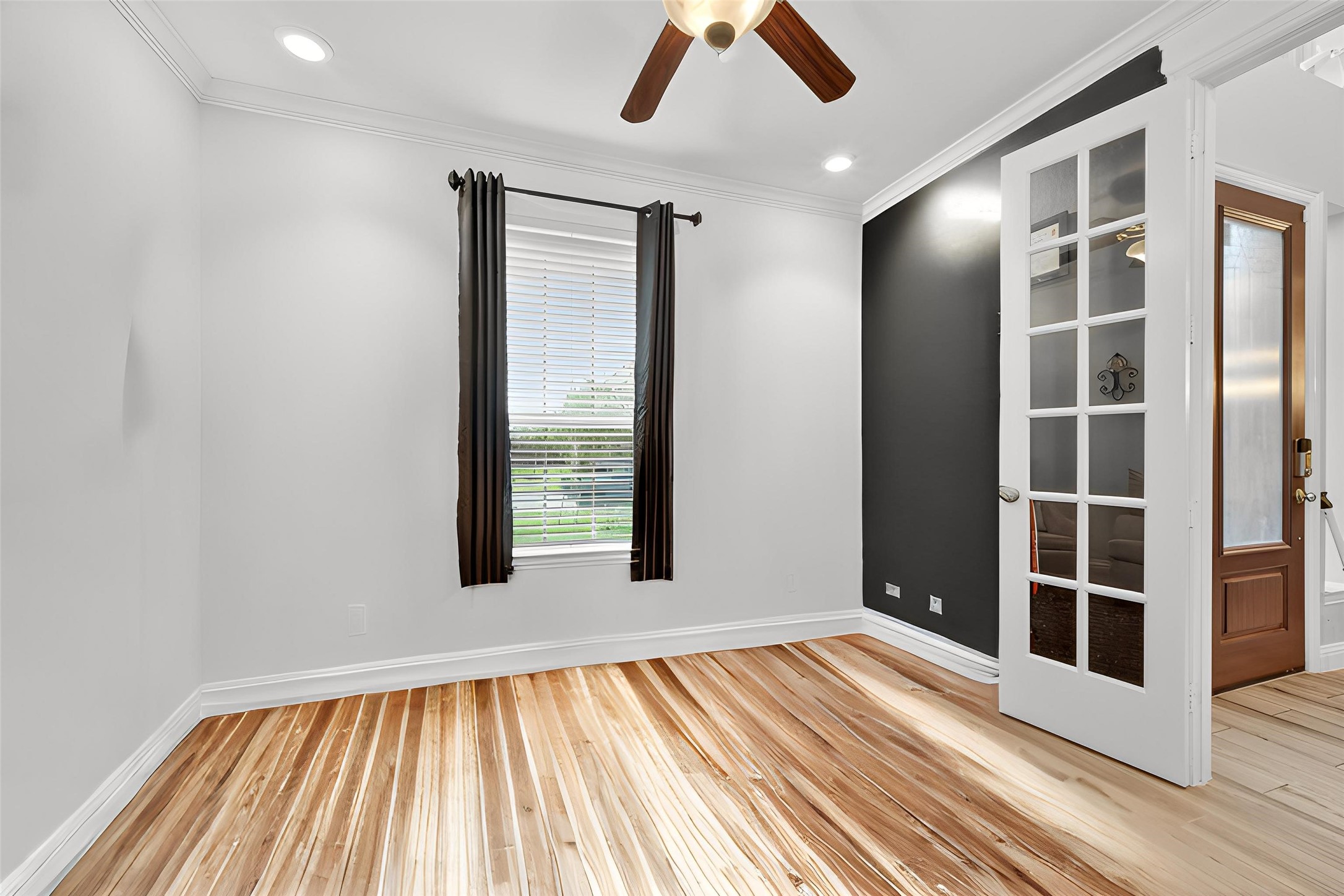 4719 Prairie Springs Lane Rosharon, TX 77583 - Photo 3 of 33 an empty room with wooden floor and windows