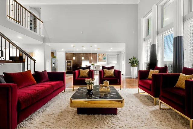 a living room with furniture fireplace and a large window