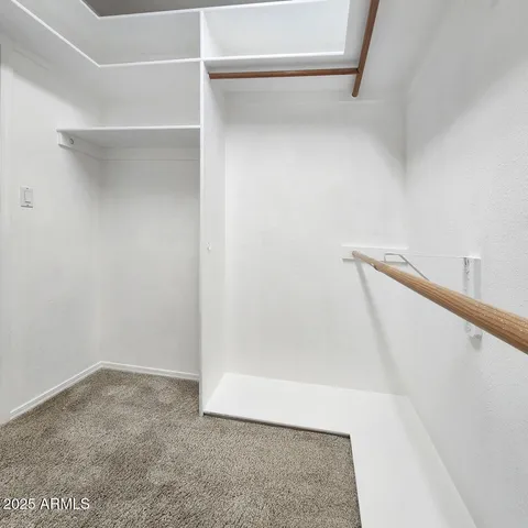 a bathroom with a sink a toilet a mirror and shower