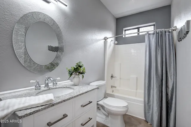 an empty room with chandelier fan