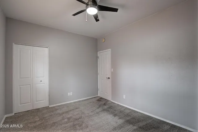 a view of a livingroom with a ceiling fan and window