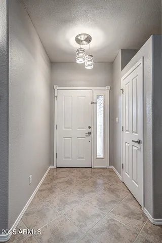 a view of an empty room with a fireplace and a window