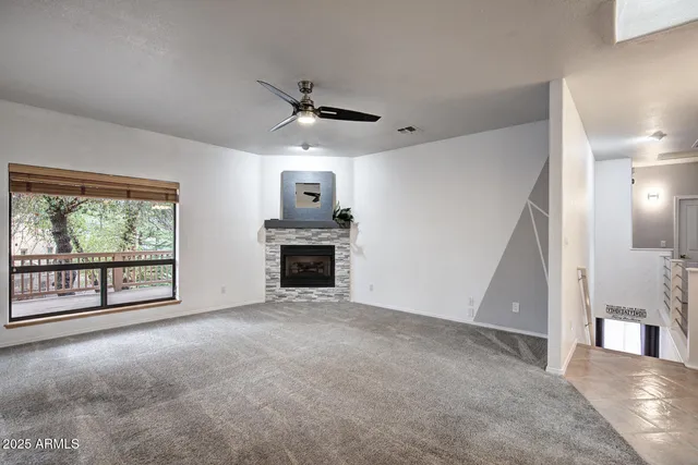a view of a livingroom with a fireplace and window