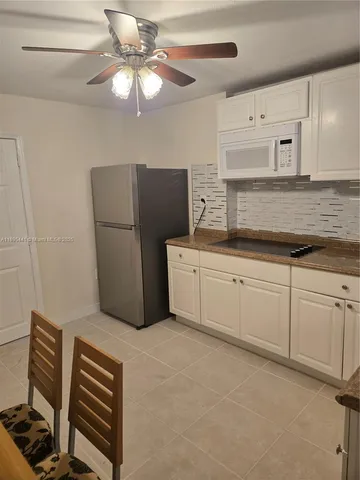 a kitchen with a cabinets and chandelier