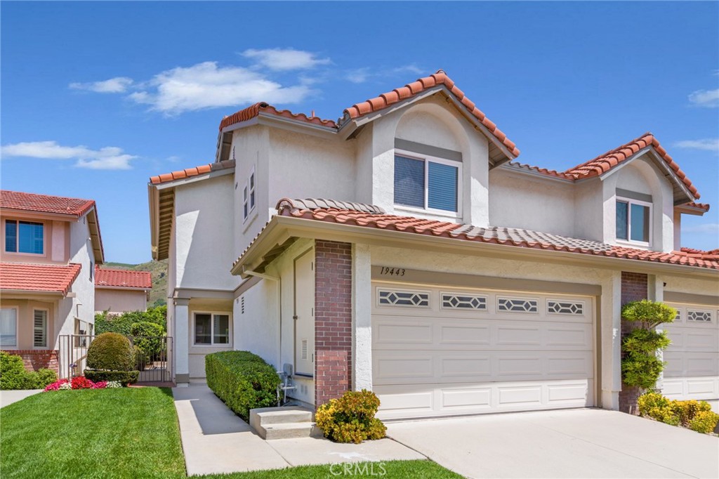 19443 Crystal Ridge Lane Porter Ranch, CA 91326 - Photo 1 of 1 a front view of a house with garden