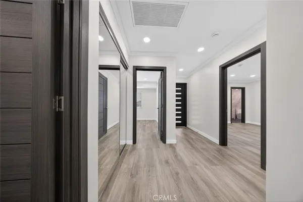 a view of hallway with wooden floor and stairs