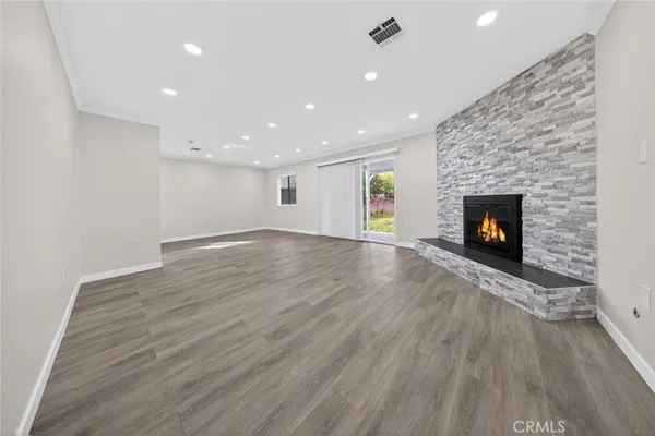 a view of a room wooden floor and fire place