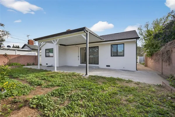 a kitchen with stainless steel appliances granite countertop wooden floor a refrigerator and a stove top oven