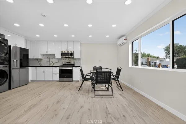 a view of kitchen with refrigerator microwave and wooden floor